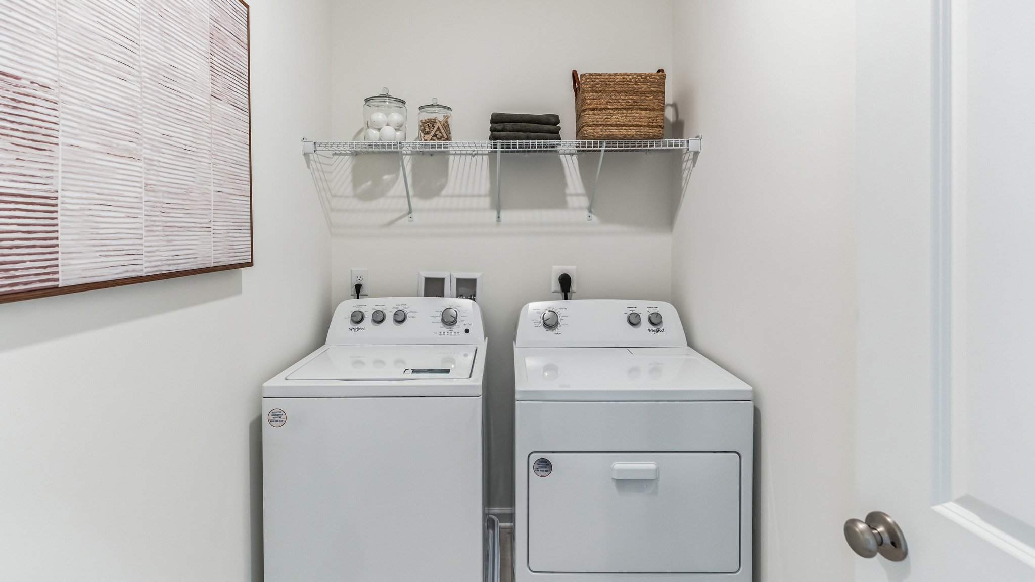 Connecting bath to the primary bedroom with double sink white vanity and glass door shower.
