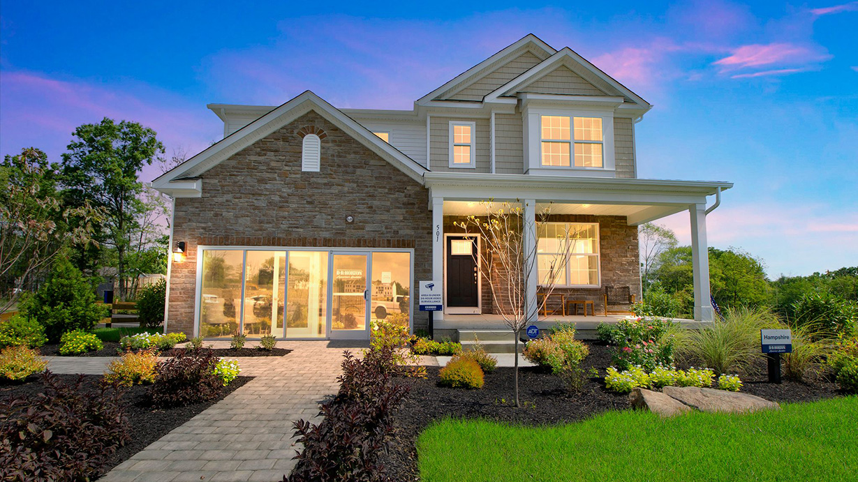 Exterior front image of a two story gray and stone home with double garage.