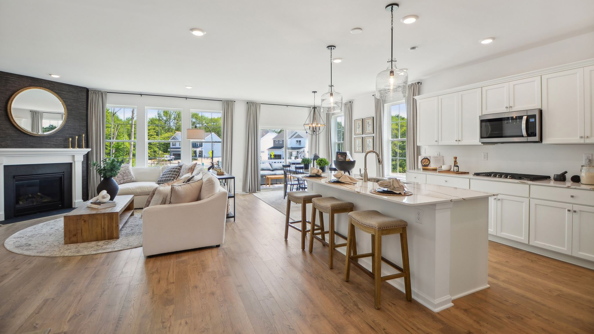 Full open concept view of the entire kitchen and living area looking towards the back porch.