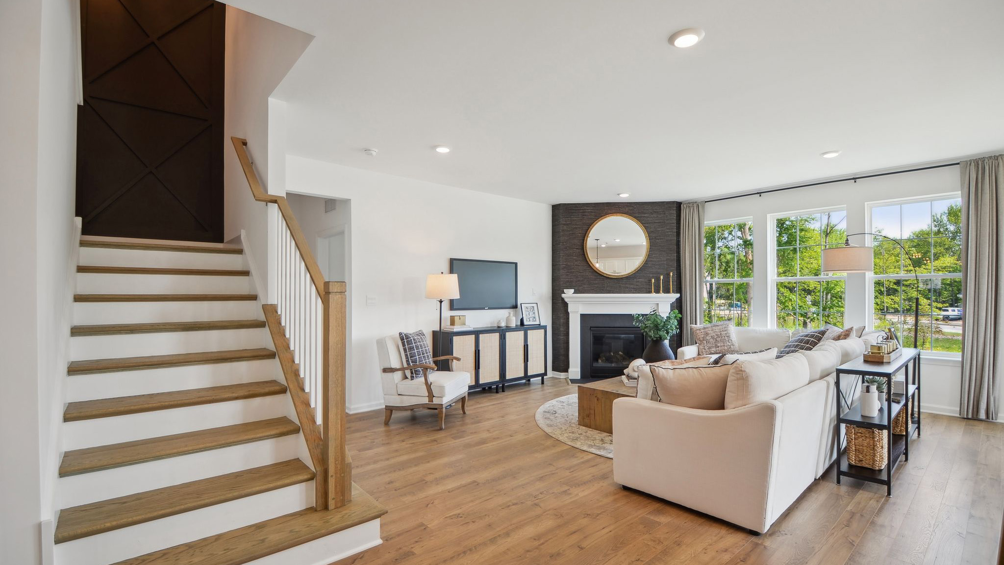 Standing next to the stairs overlooking the stairwell and living area.