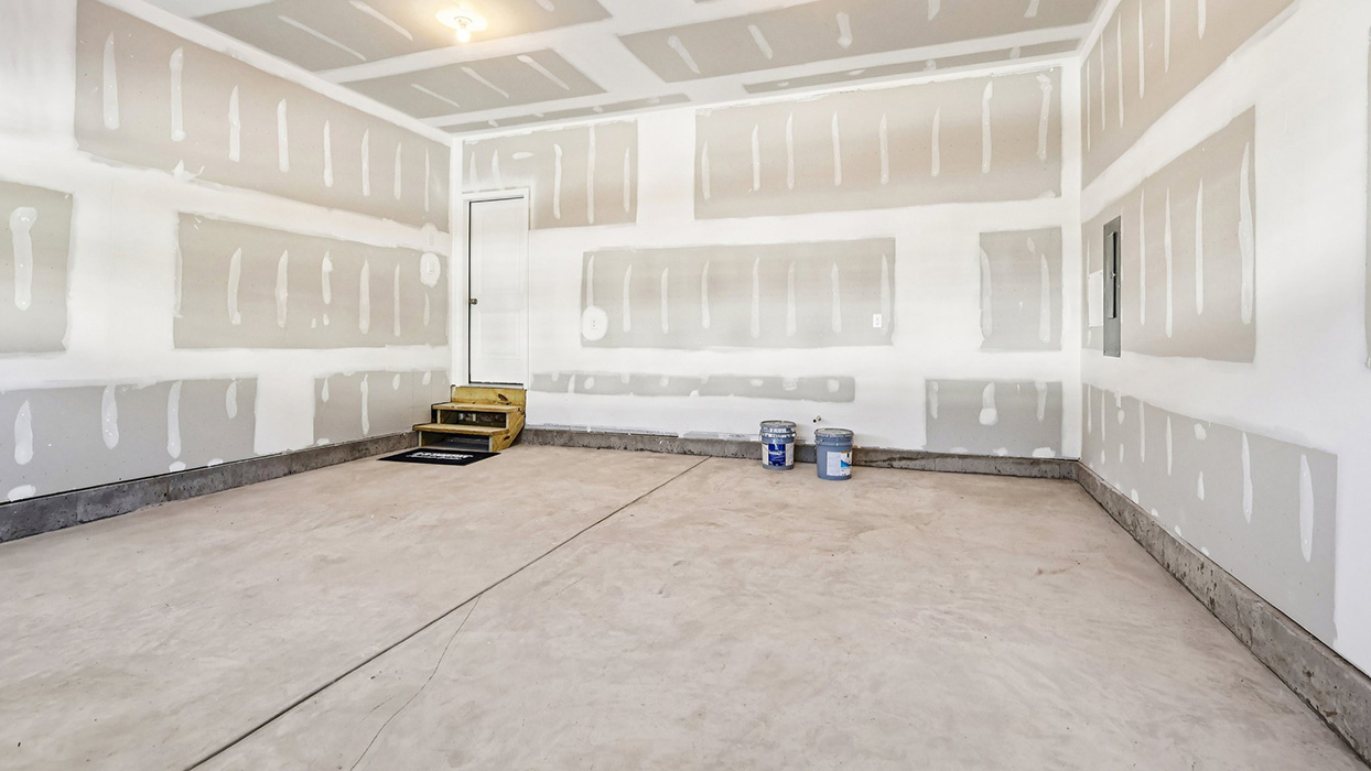 Inside the garage looking back towards the entry way door to the home