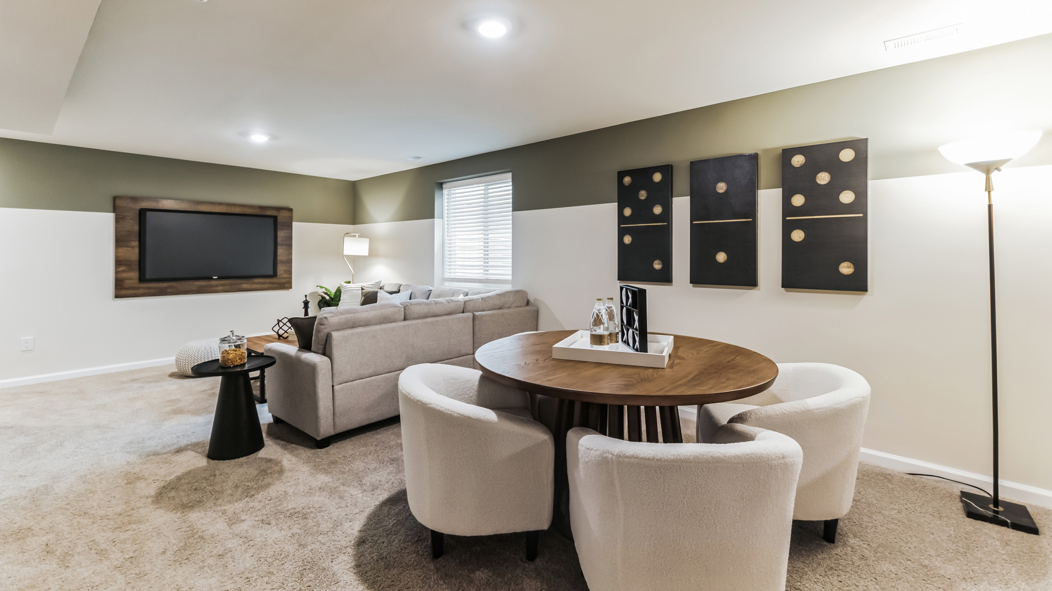 Another view of the basement living and dining area with the dining area closest.