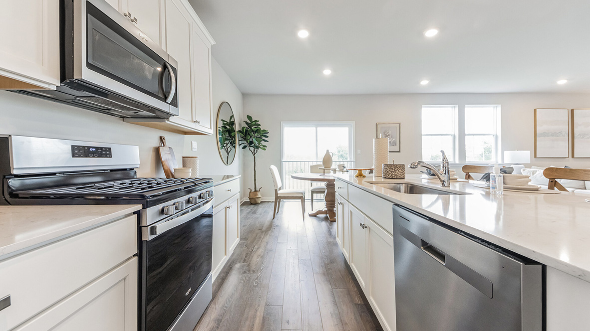 The walkway between the wall of the kitchen and the island looking towards the dining area.
