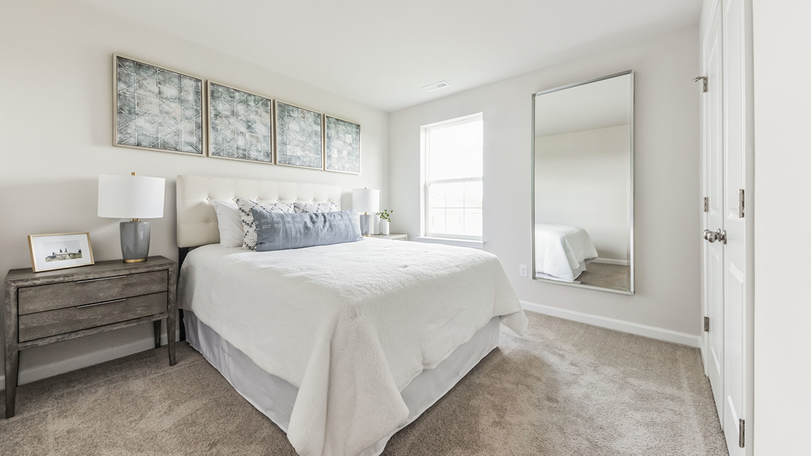 Bedroom with a single window and double door closet.