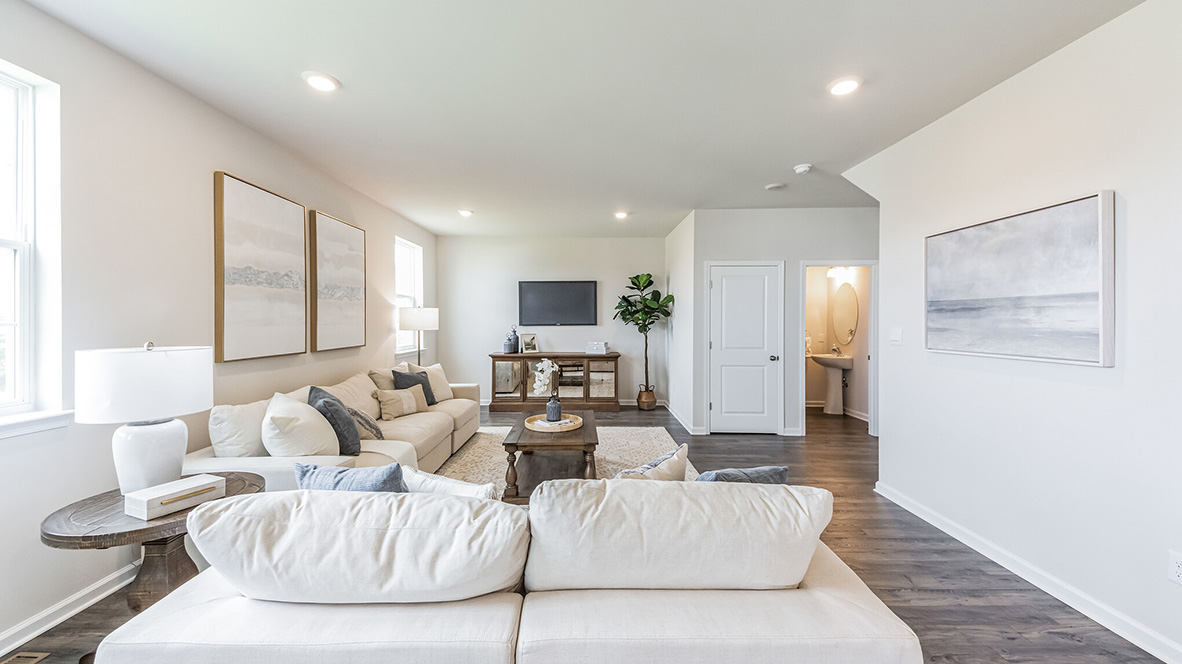 Spacious living area with extra storage closet and half bath.