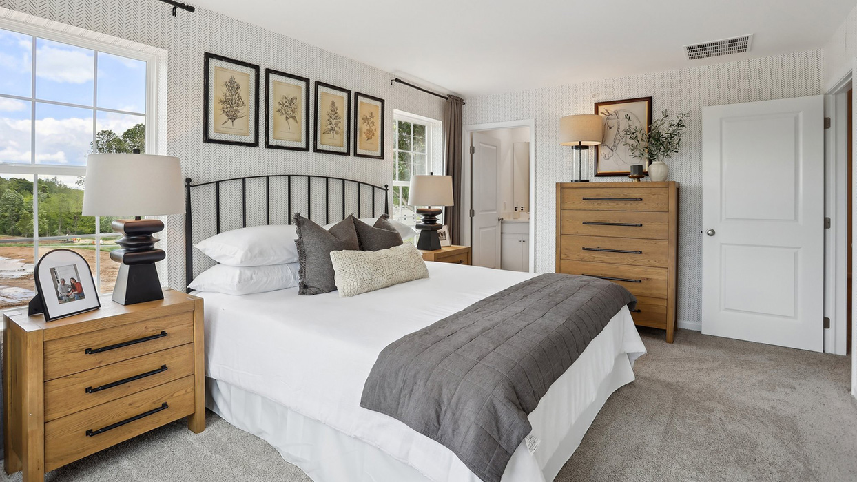A different view of the primary bedroom with view to bathroom door.