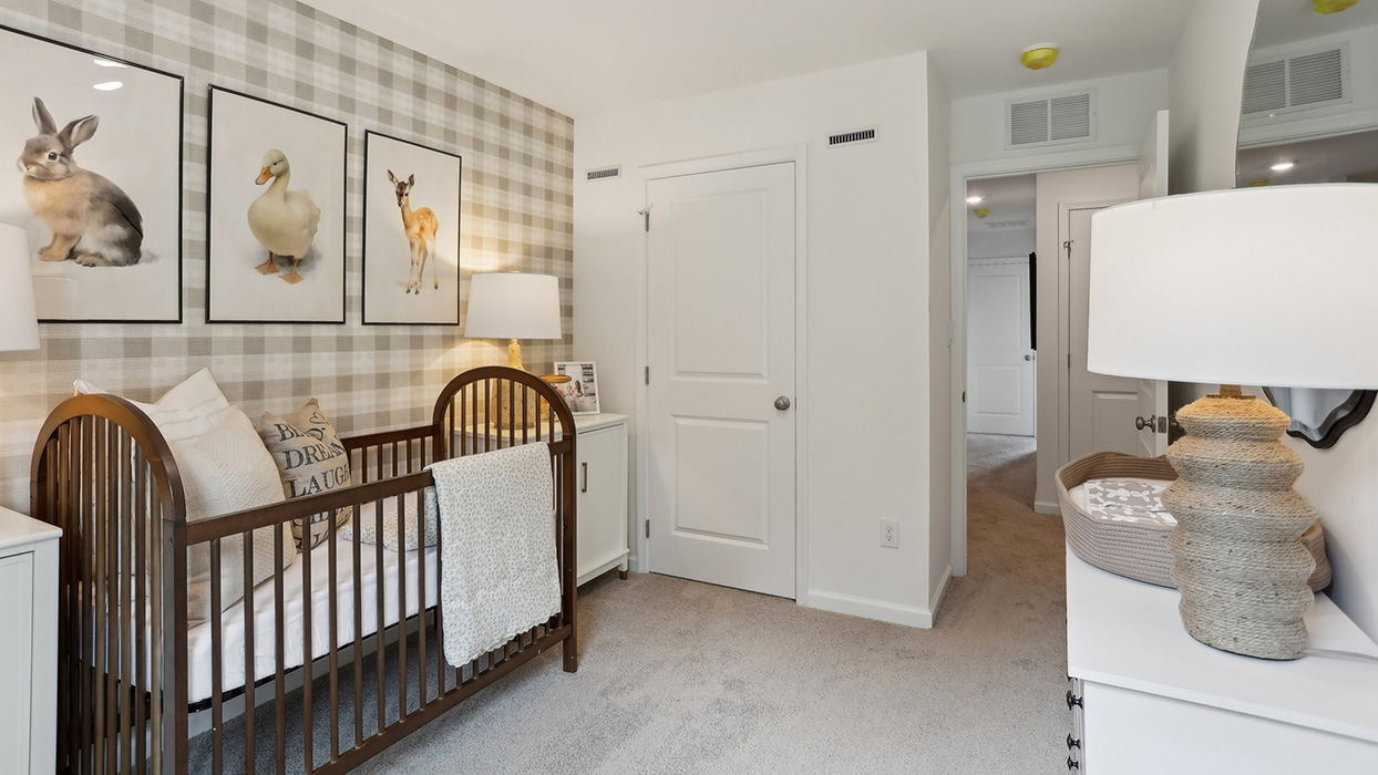 A different view of the second bedroom with closet door in view.
