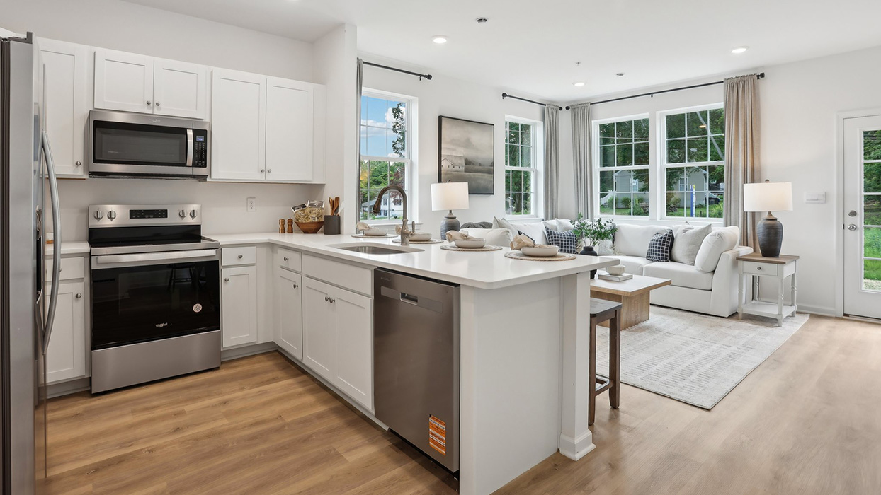 Behind the kitchen counter with view of the sink.