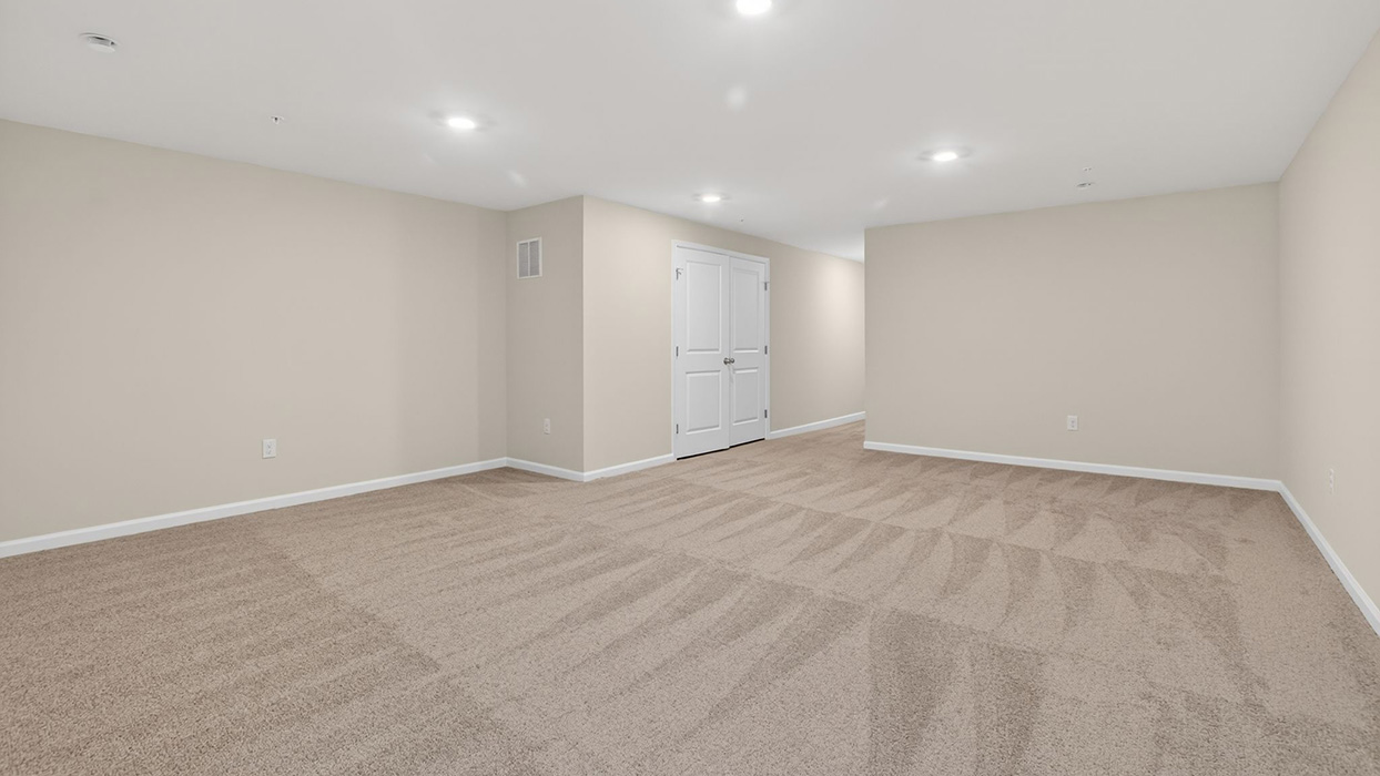 The finished basement with view towards mechanical closet.