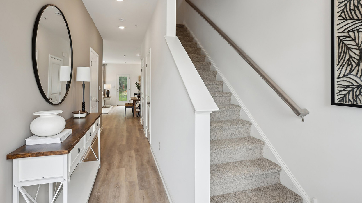 The foyer entrance with stairs to the second floor to the right.
