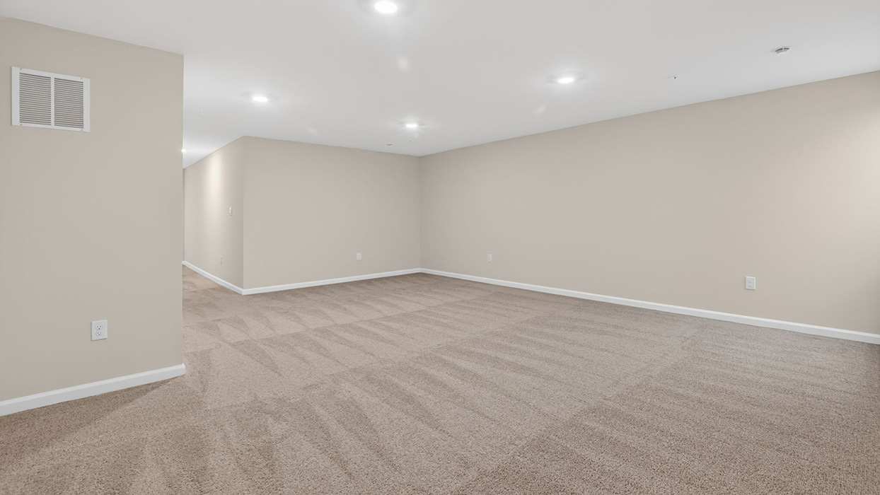 The finished basement with recessed lighting.