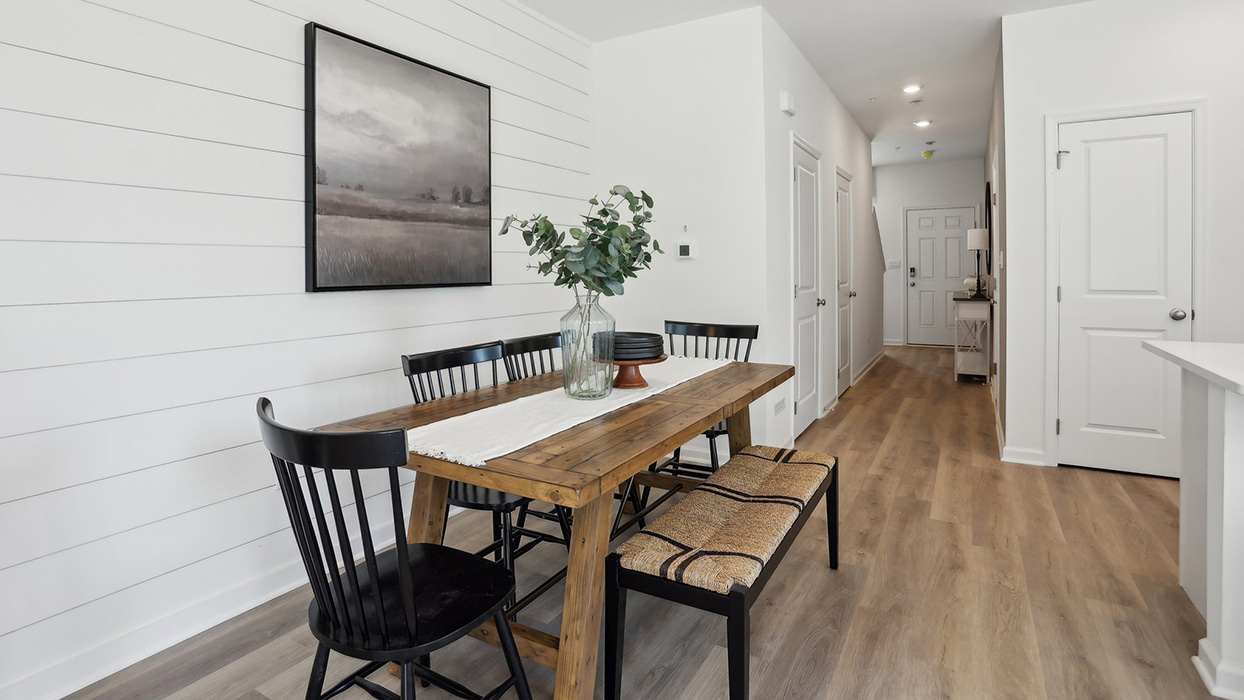 The dining area with a peek down the hallway to the foyer entrance.