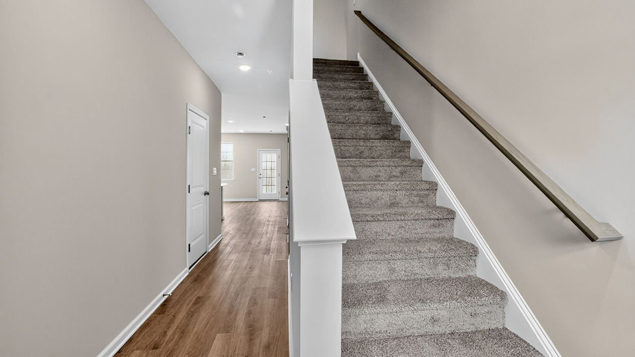 The foyer entrance with stairs to the second floor to the right.