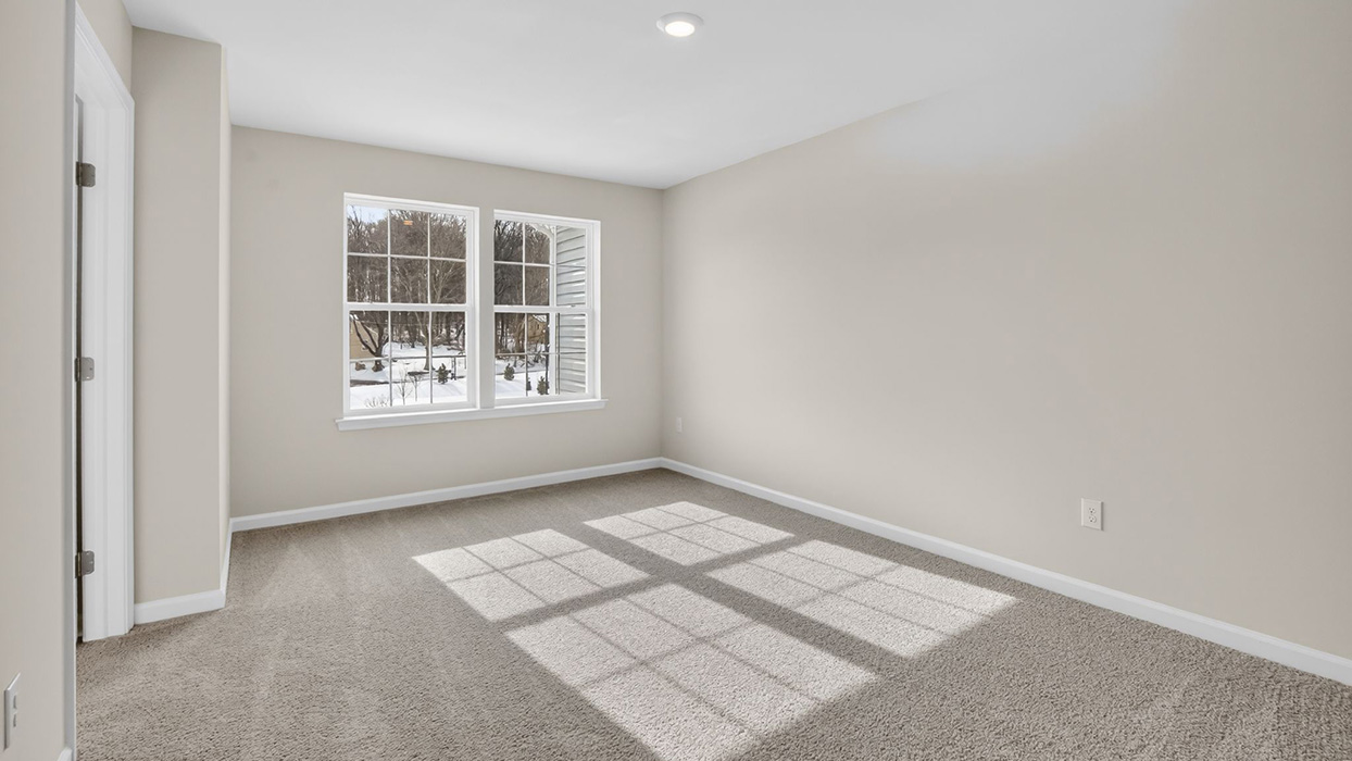 Primary bedroom with large double window.
