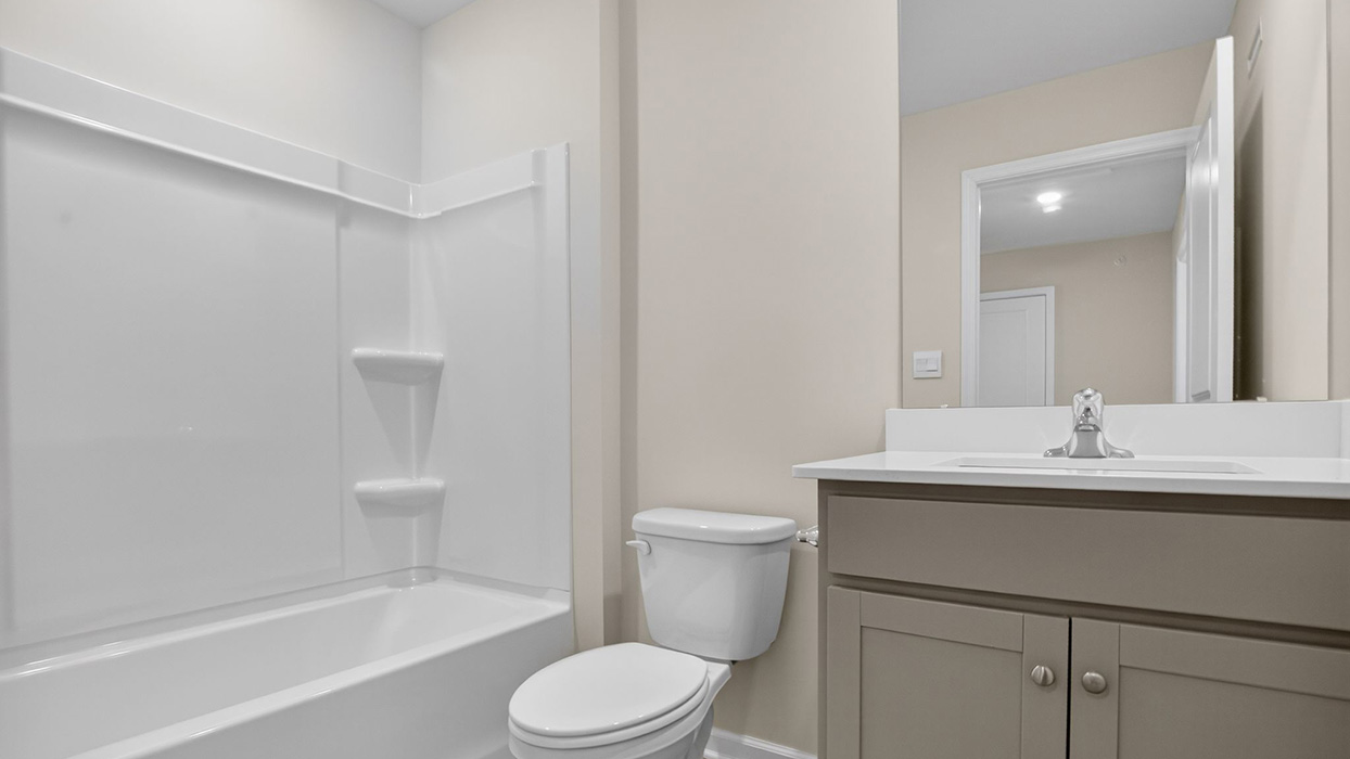 Full bath with single sink counter and vanity and bathtub.