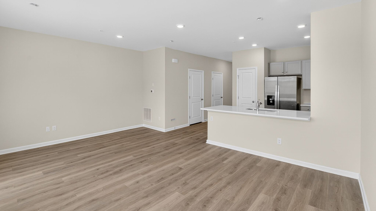 The dining, living, and kitchen area in view for an open concept plan.