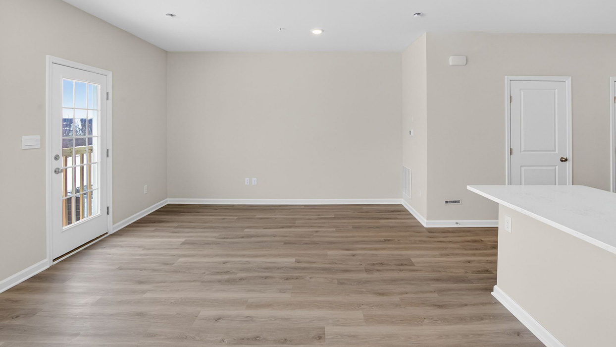 The dining, living, and kitchen area in view for an open concept plan. View of the back door.