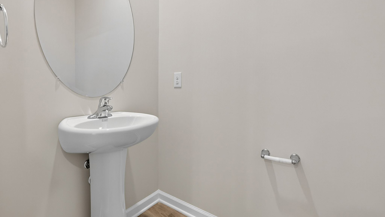 Half bath with single sink on the first floor.