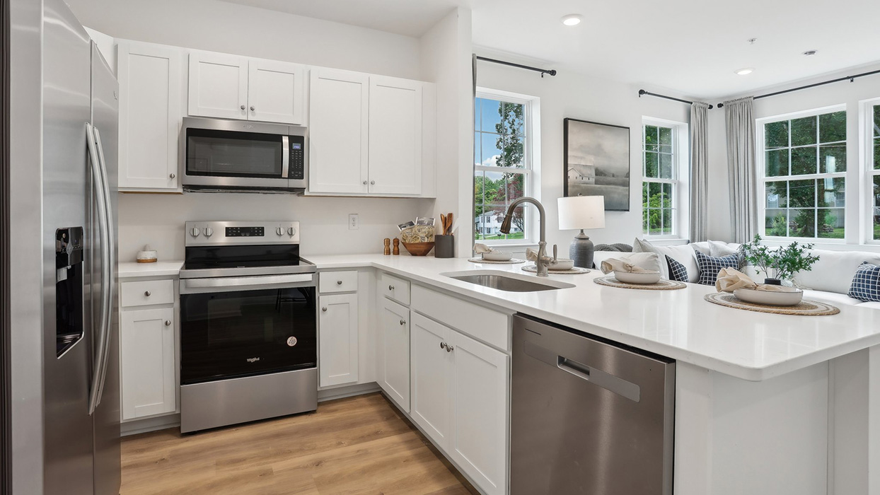 A slightly different kitchen view with a better view of the overhead recessed lighting in the kitchen and living area.
