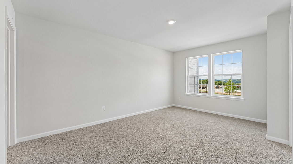 Bedroom with plush carpet flooring and double windows allowing natural light and exterior views
