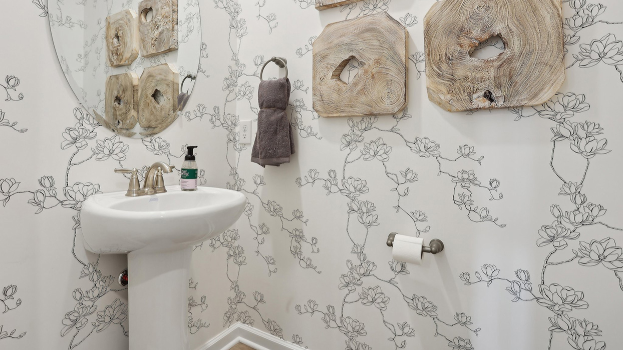 Half bath with single sink on the first floor.