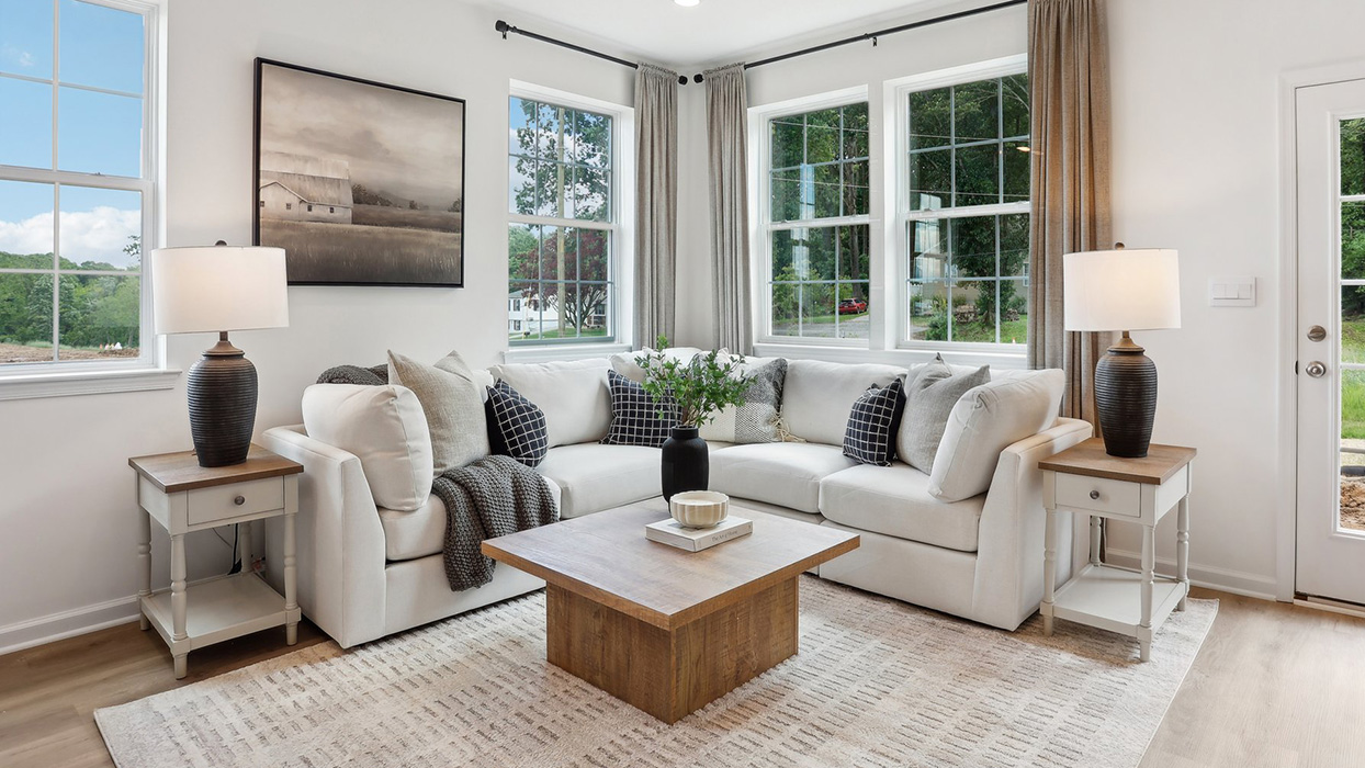 First floor living area with three large windows and rear door.