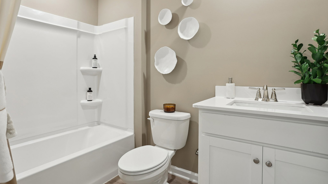 Full bath with single sink counter and vanity and bathtub.