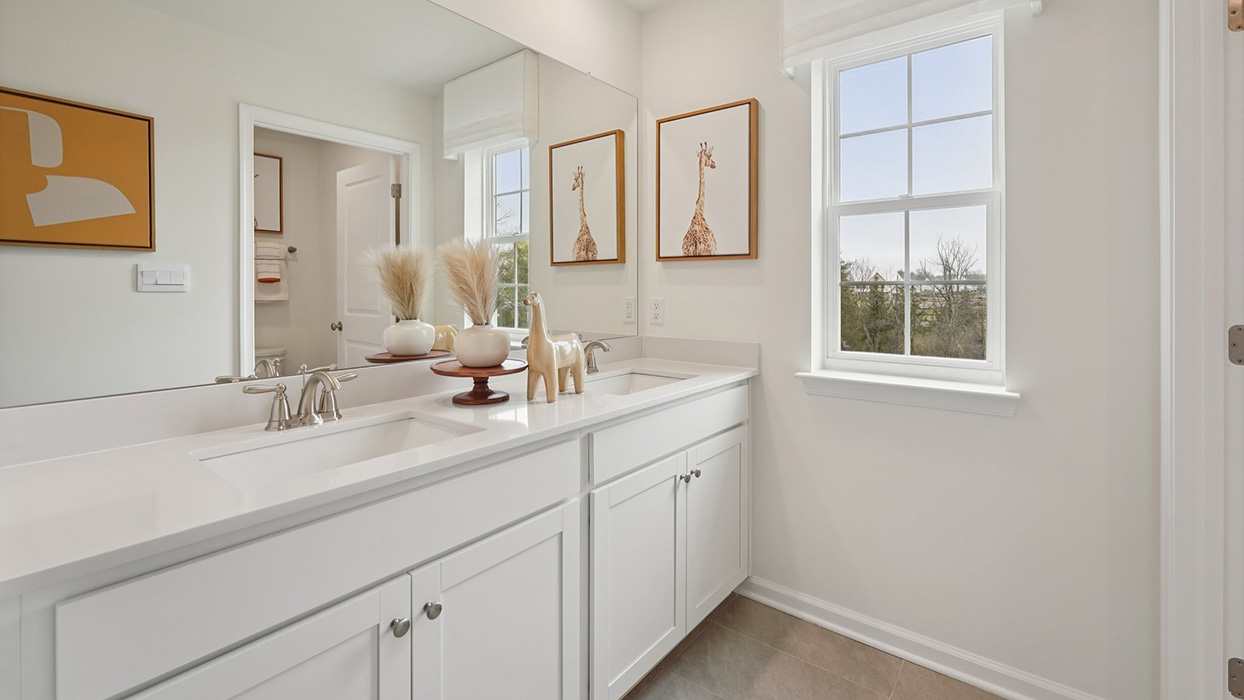 Three generously sized secondary bedrooms, and a hall bathroom with double vanity complete the upstairs.