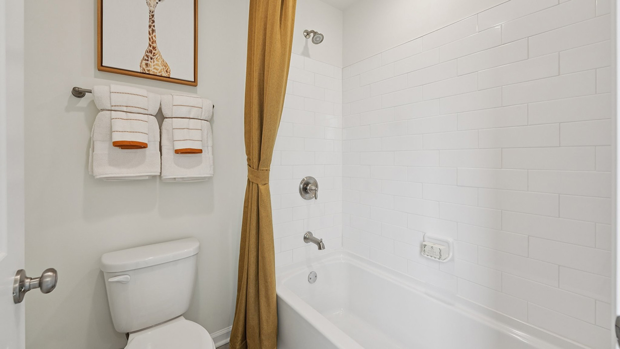 Three generously sized secondary bedrooms, and a hall bathroom with double vanity complete the upstairs.