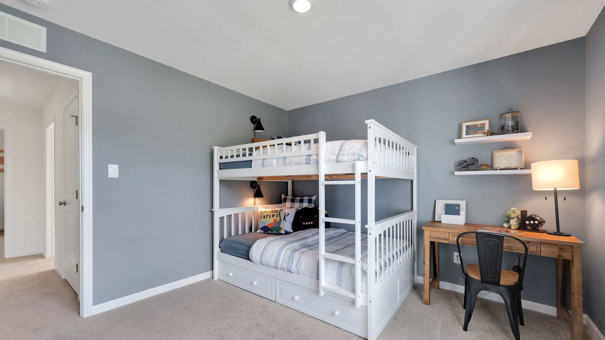 Three generously sized secondary bedrooms, and a hall bathroom with double vanity complete the upstairs.