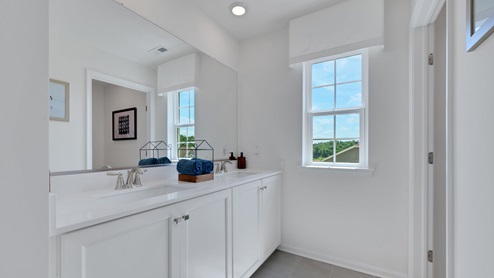 Three generously sized secondary bedrooms, and a hall bathroom with double vanity complete the upstairs.