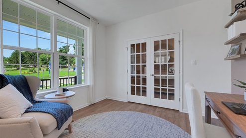 The study with two large windows and facing two french doors into the foyer.