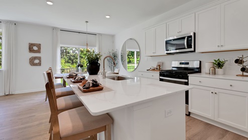 The kitchen island features a single sink.