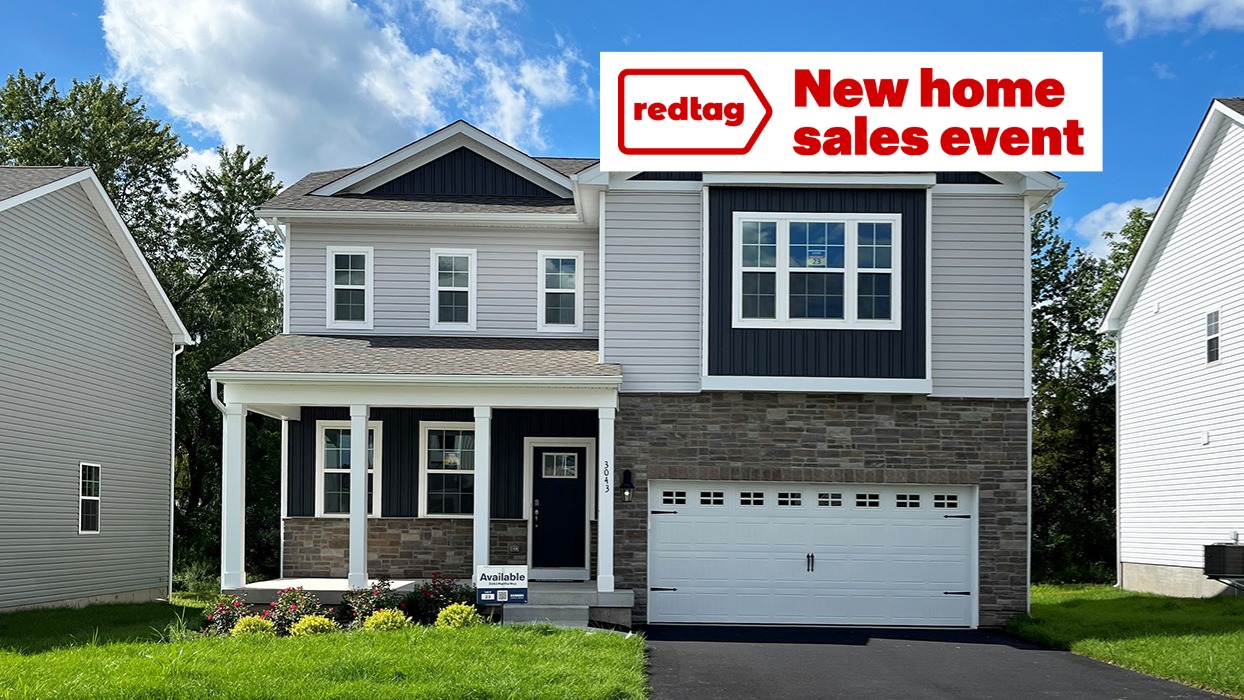 A photo of a two-story Galen home with sterling siding, ironstone board and batten accent siding, dakota ledge stone kneewall, and dakota ledge stone siding surrounding a white two car garage.