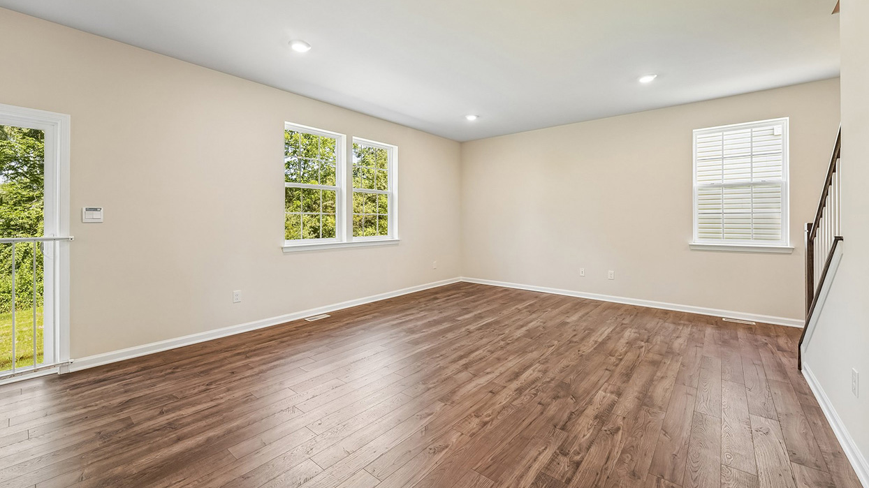 Entry foyer and flex space in the Galen single-family home at Creekside Village with natural light, luxury vinyl plank flooring, and an open layout.
