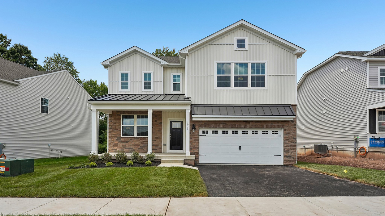 Front elevation of Galen home showcasing landscaped yard, driveway, covered entry, and modern farmhouse exterior design