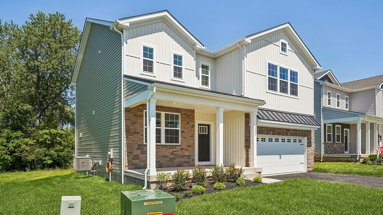 Angled exterior view of Galen single-family home with covered front porch, mixed siding, and attached two-car garage