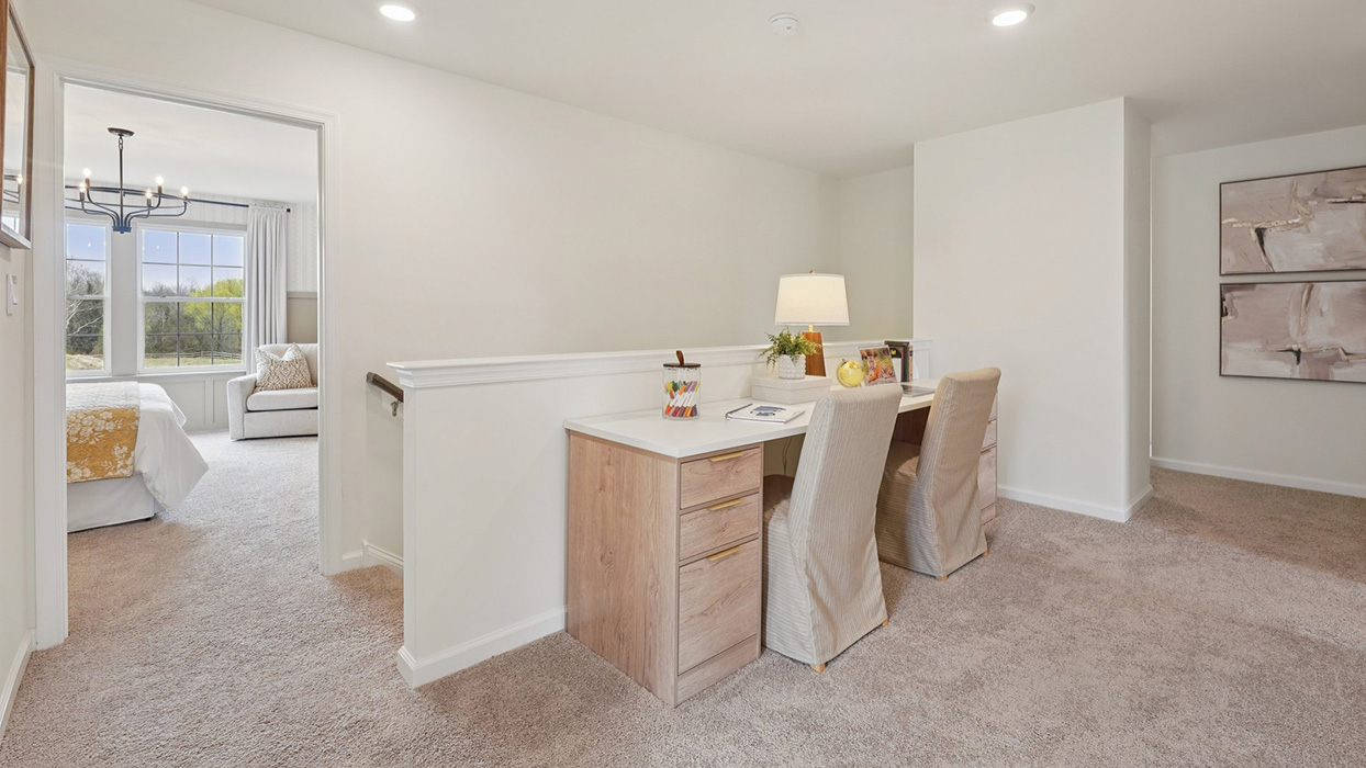 The upstairs landing can fit a table for projects or as a student's homework space.