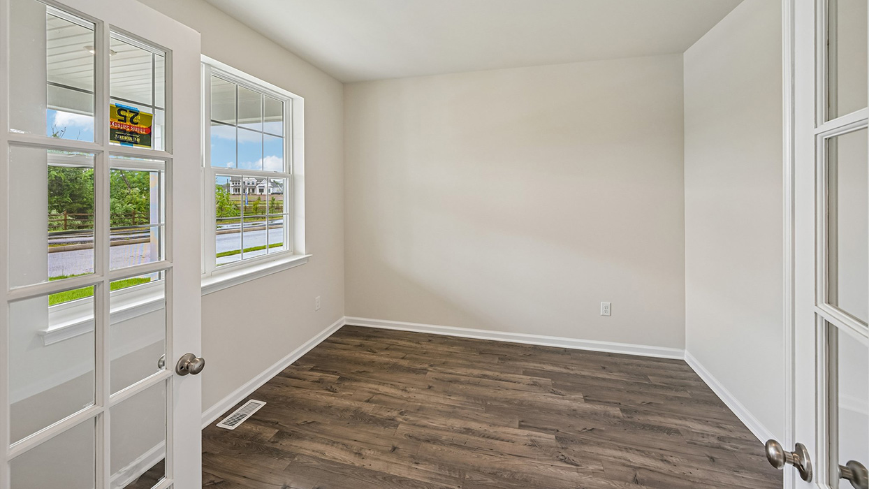 Flex room or study with large windows, natural light, and open floor space