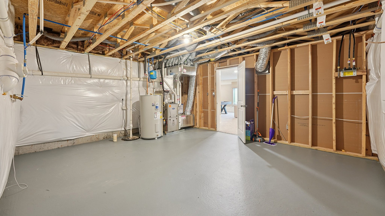 An unfinished basement space with utilities.