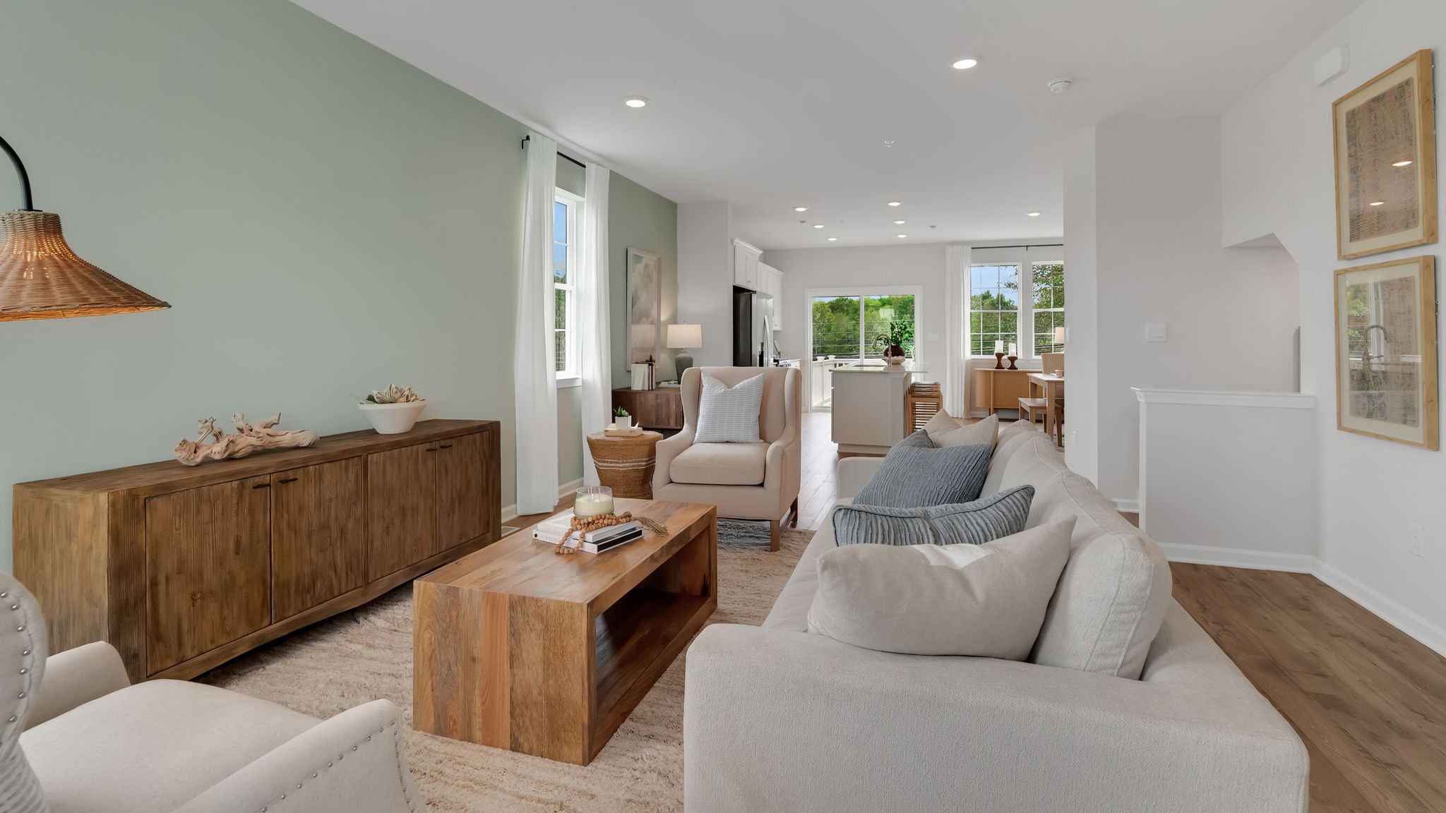 Living area with the kitchen and dining area in the back.