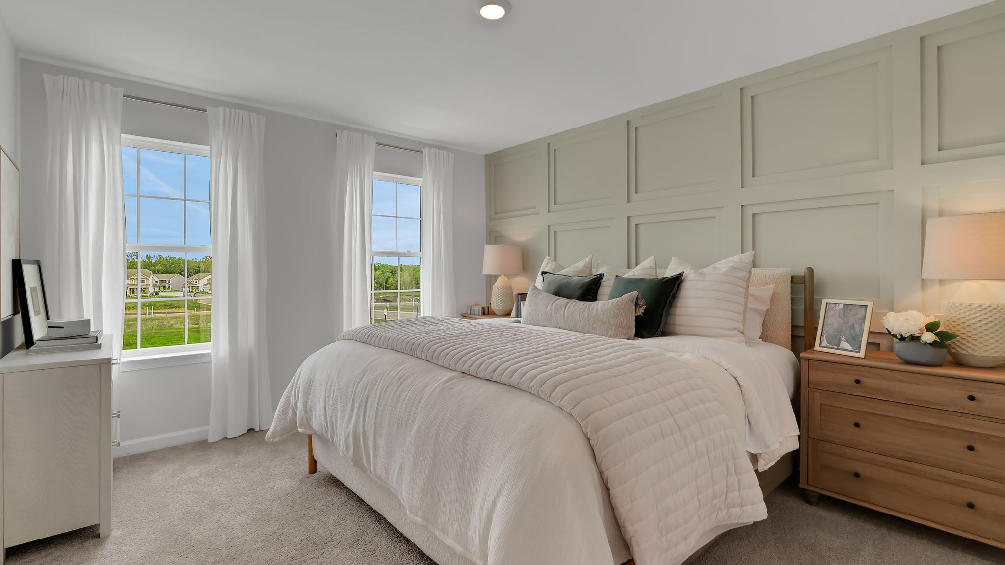 Different view of the bedroom with the connecting bathroom and two single windows.