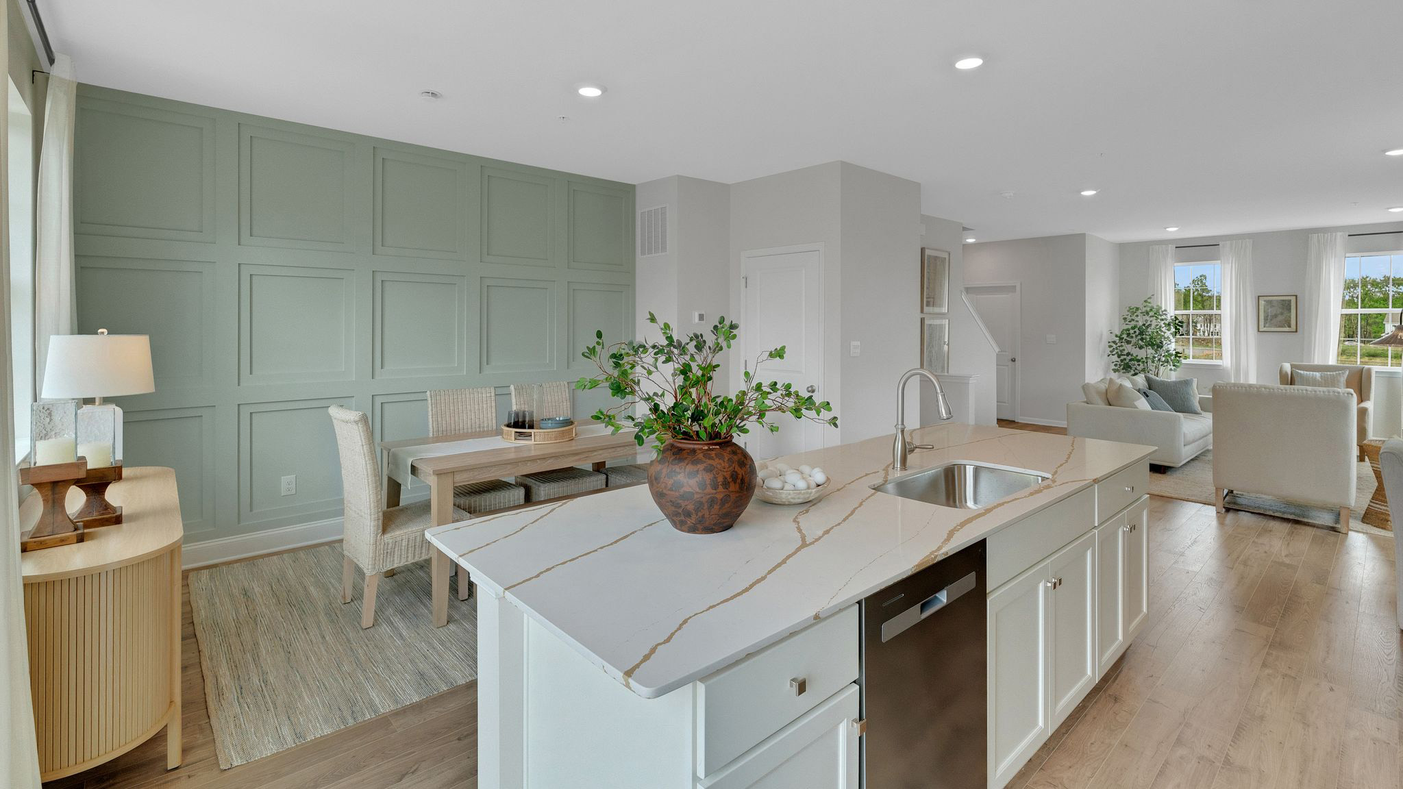 Front side of kitchen island with views of the dining area and a peek into the living area to the right.