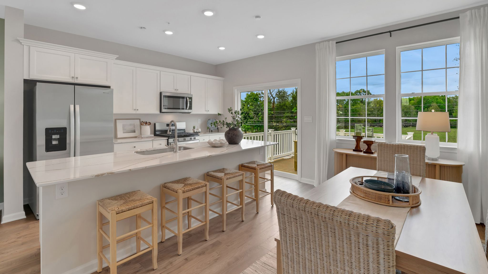 Kitchen and dining area with view of the glass sliding balcony door.