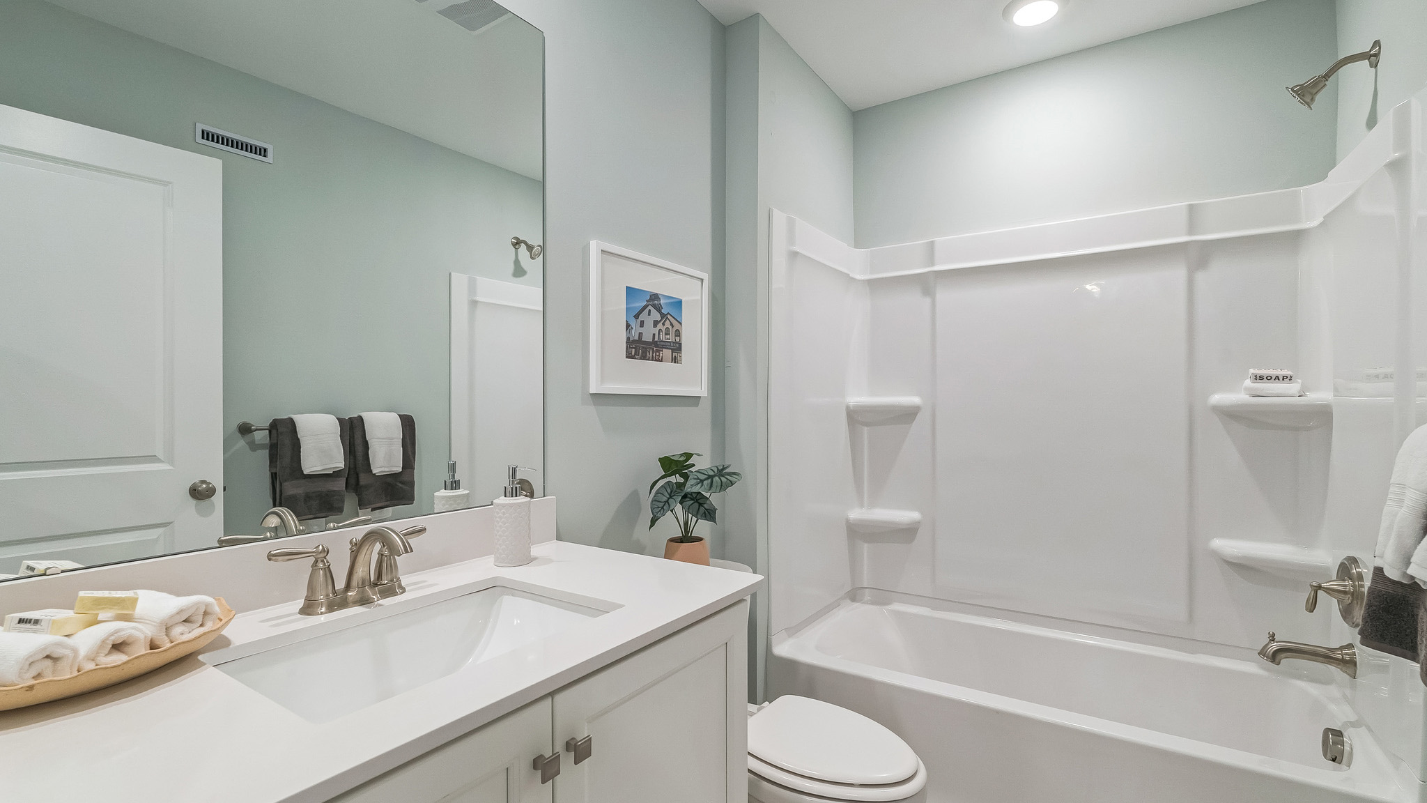 Full bath with white counter and vanity and bath tub.