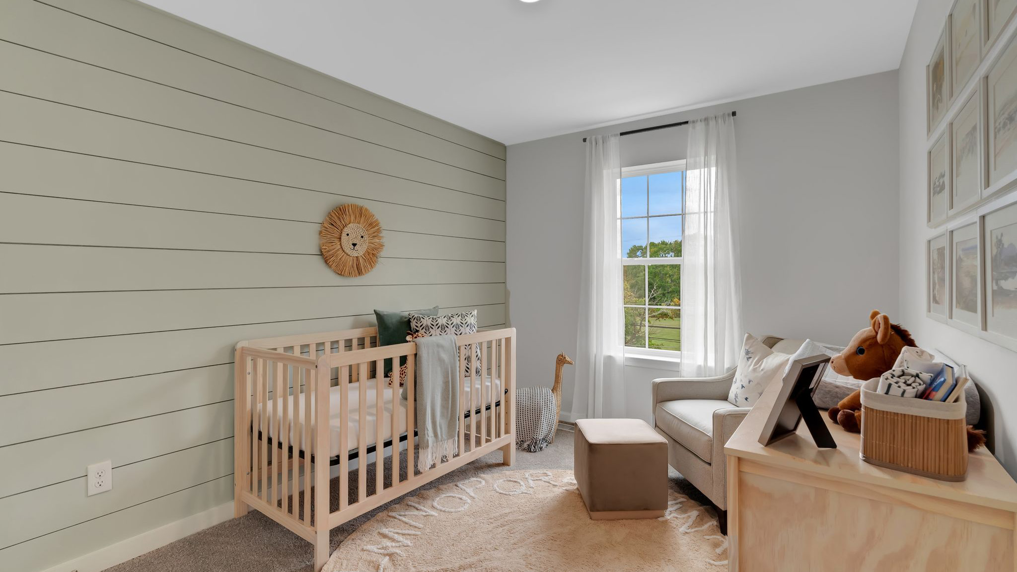 Bedroom with olive shiplap accent wall on the first floor.