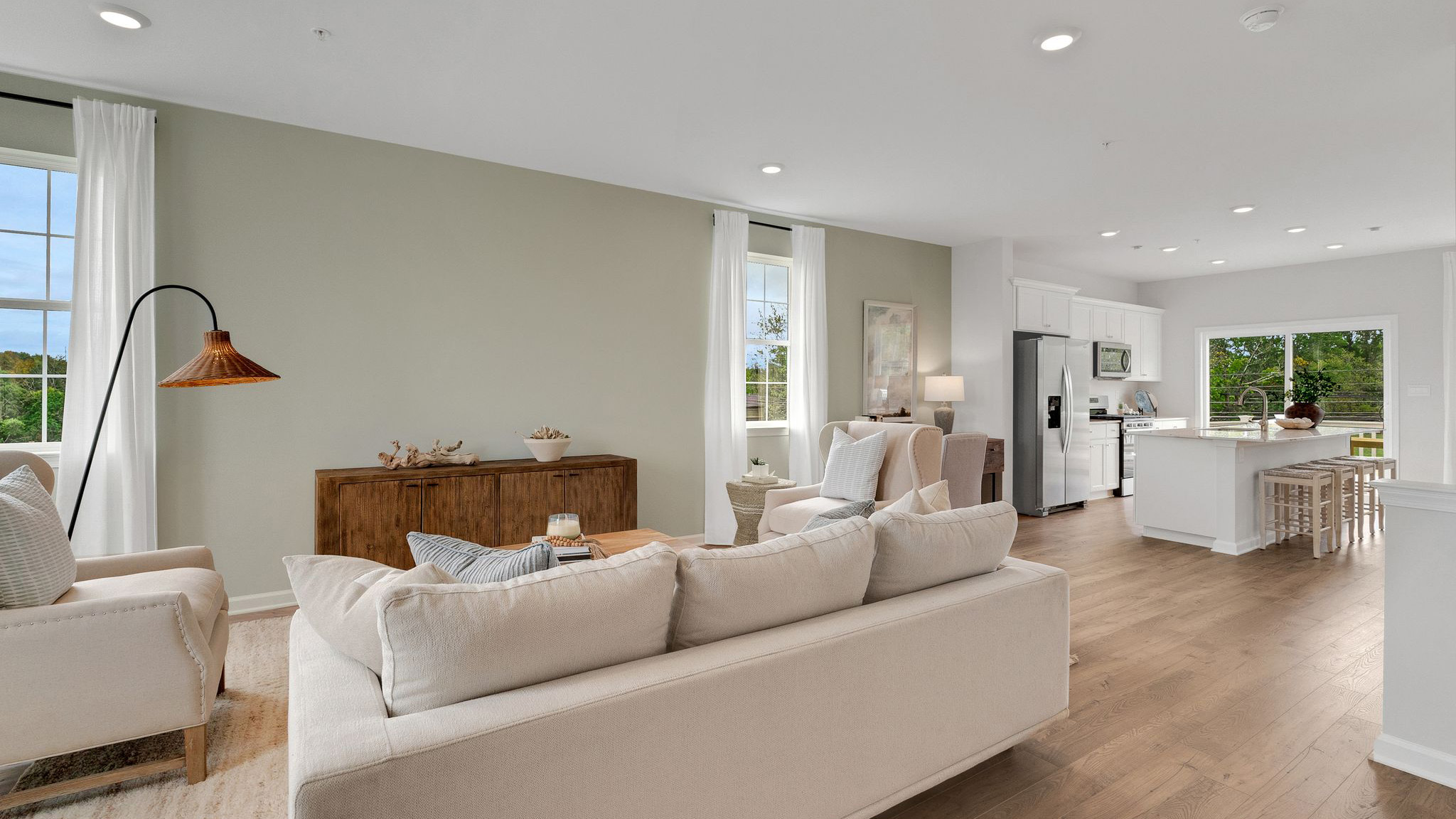 Living area facing where a TV could possibly go with the kitchen to the right.
