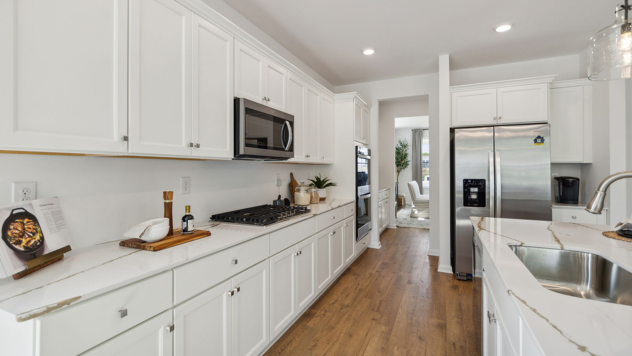 The walkway between the kitchen wall and the island with a peek into the dining area.