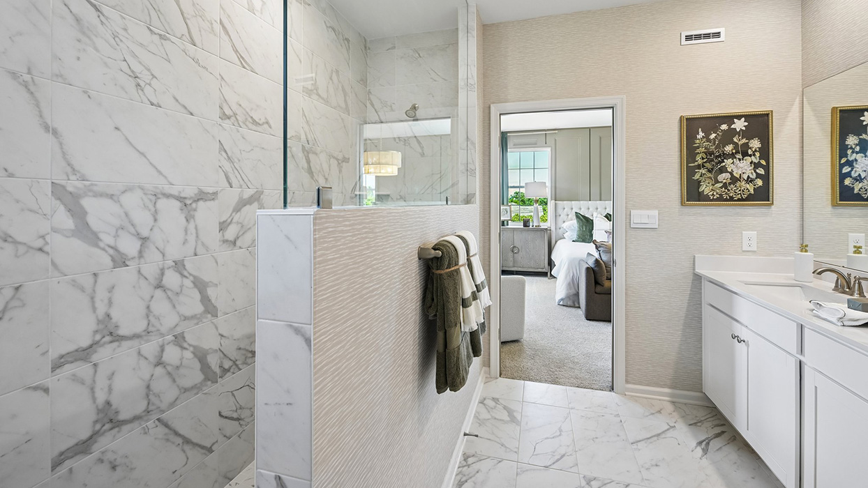 Master bathroom has walk-in glass shower.