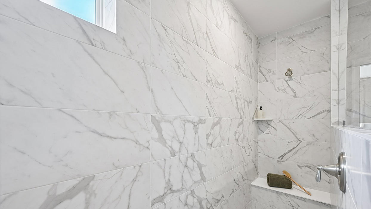 Master bathroom has walk-in glass shower.